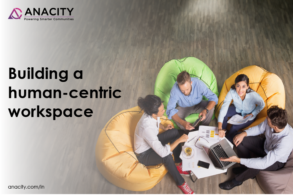 Image with professionals sitting on bean bags and the text, Building a human-centric workspace